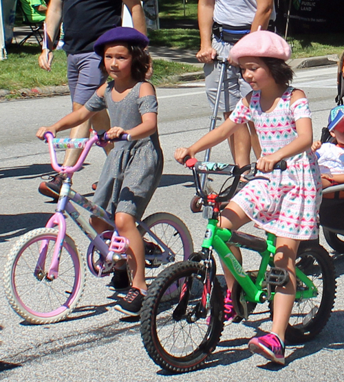 Little girls on bikes French Cultural Garden in the Parade of Flags